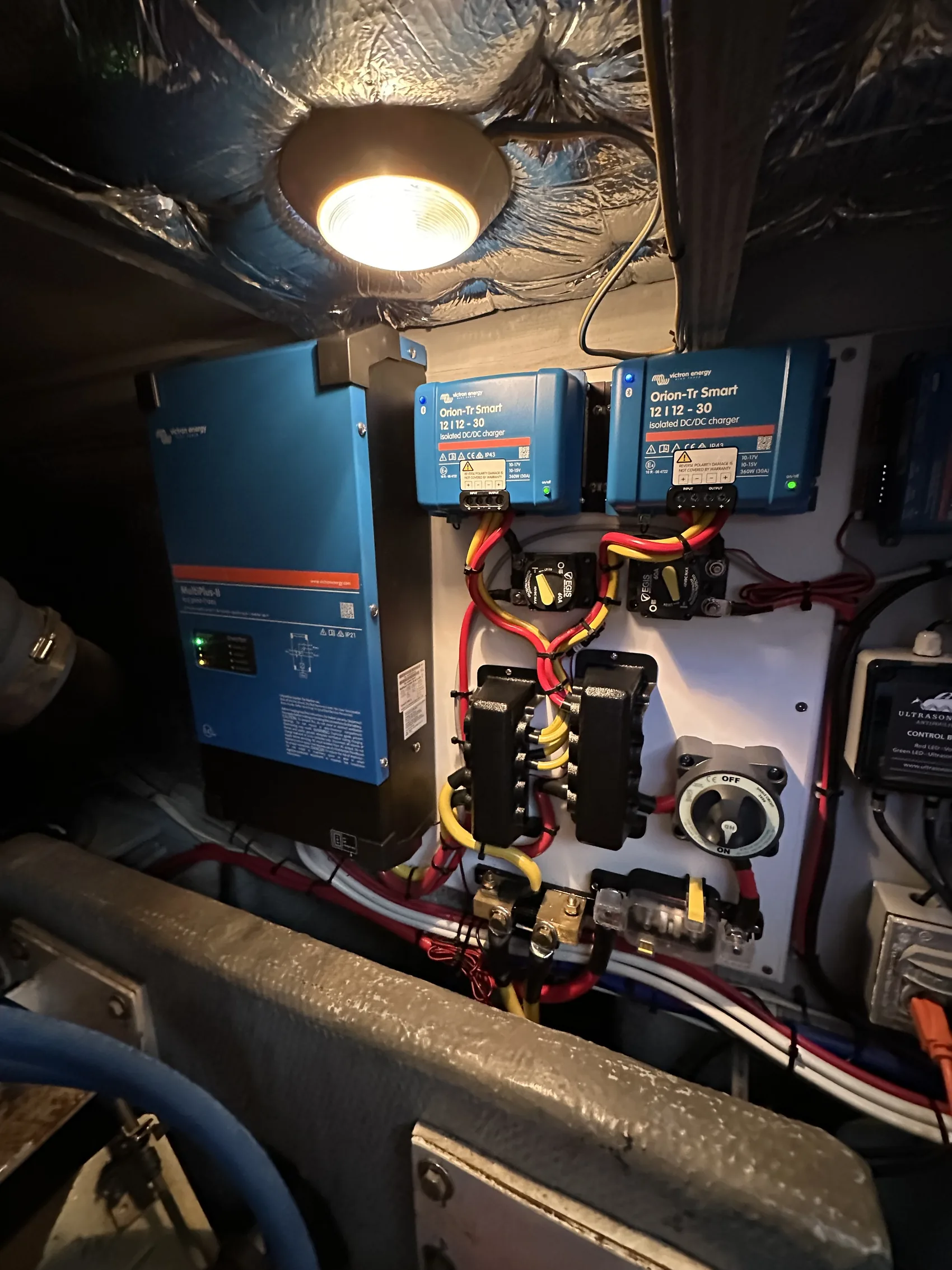 Victron inverter and monitoring stack wired and tested under a work light