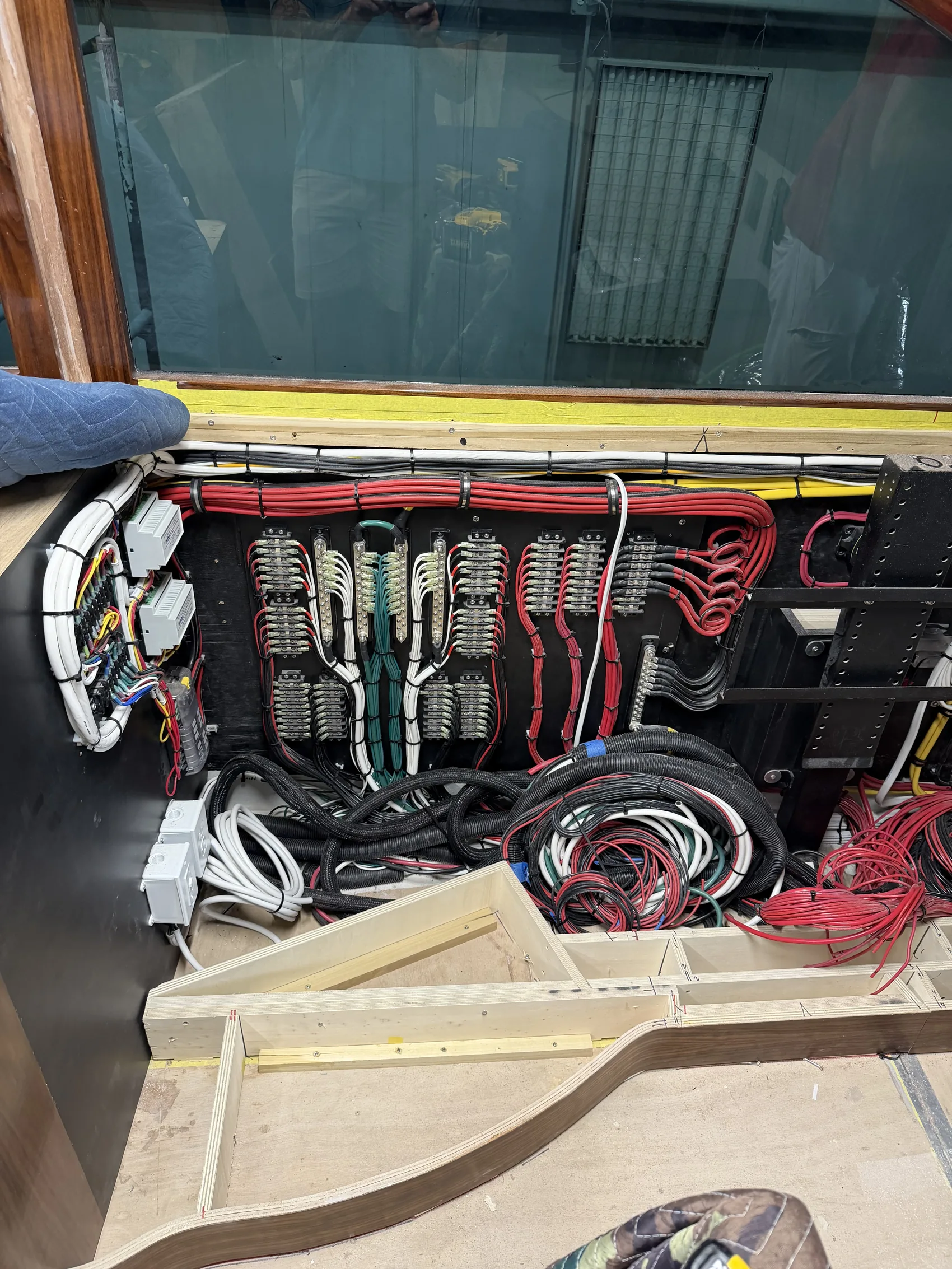 Bundled wiring runs pulled through a bulkhead during a vessel electrical refit